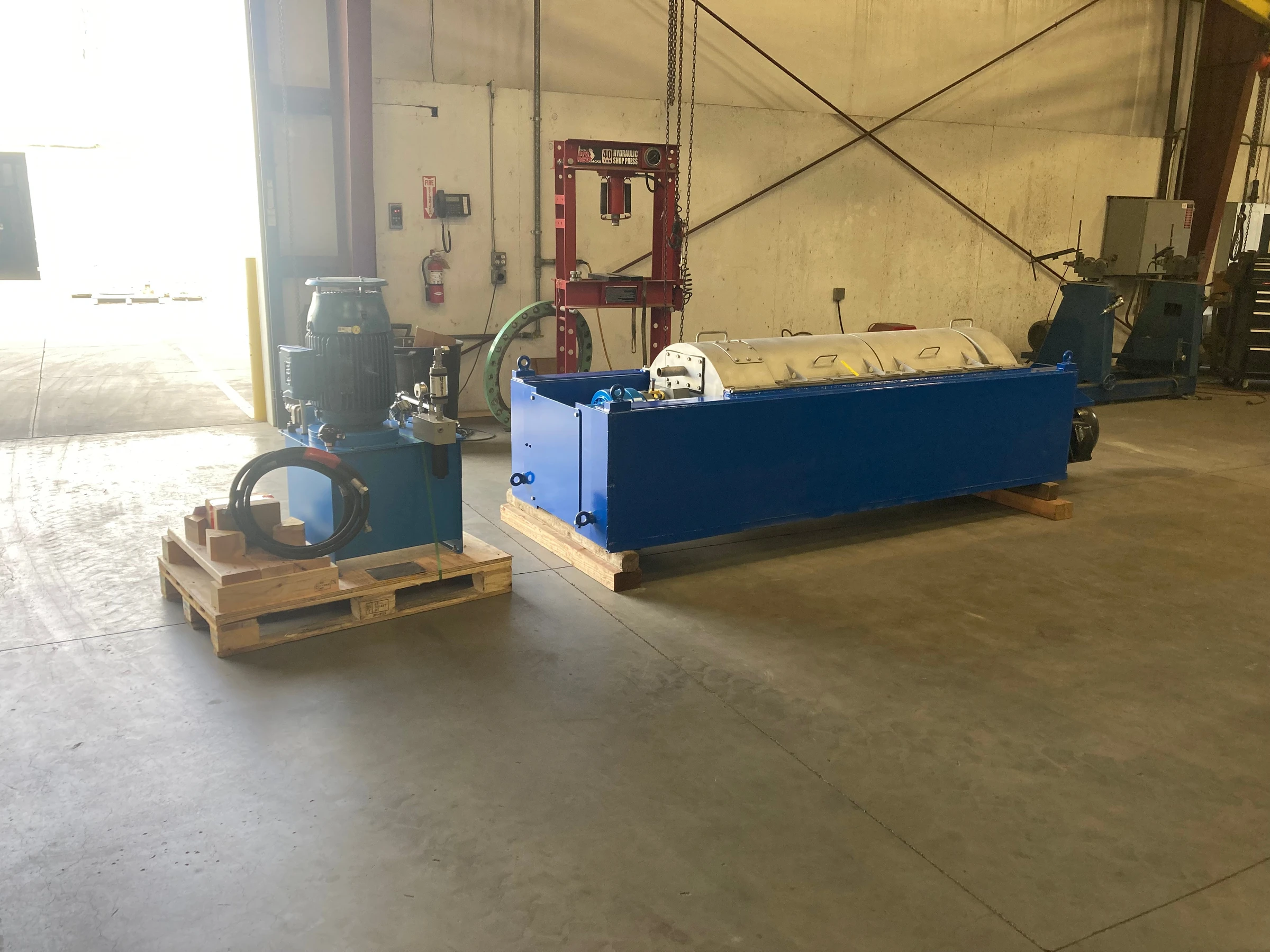 Refurbished decanter centrifuge and hydraulic power pack crated for worldwide shipping at Sully Enterprises